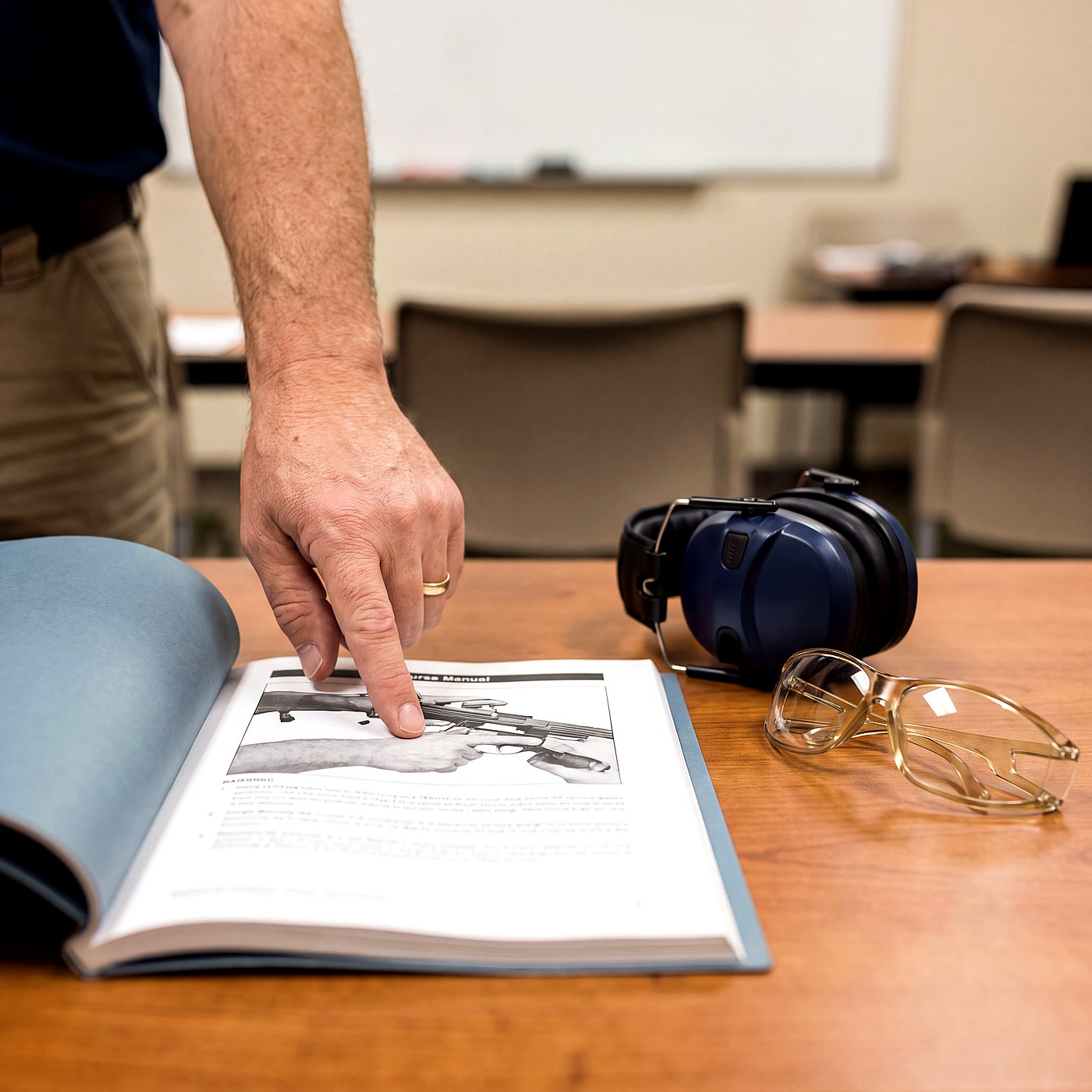 Firearms safety course materials and safety equipment on a table